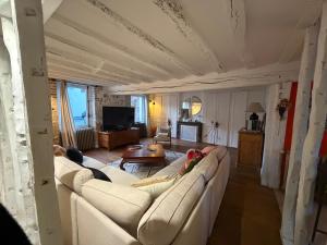 a living room with two people laying on a couch at Chez leo in Marboué