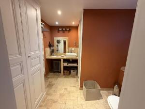 a bathroom with a sink and a toilet and a mirror at Chez leo in Marboué +4 photos