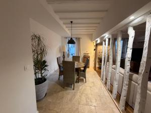 a dining room with a table and chairs at Chez leo in Marboué