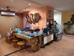 a room with a table and chairs in a store at Chiang Mai Waroros Boutique Hotel in Chiang Mai