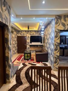 a living room with a couch and a tv at Winter Heaven in Cochin