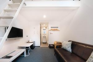 a living room with a couch and a table at Apartment Sanjo in Nara