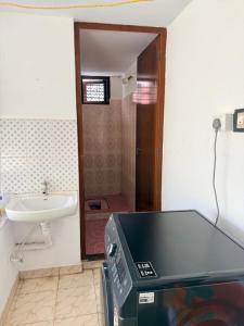 a bathroom with a toilet and a sink and a television at Winter Heaven in Cochin +38 photos