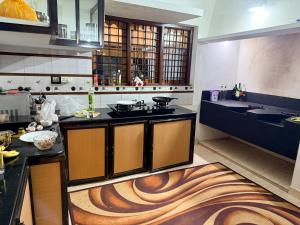 a kitchen with a stove and a counter top at Winter Heaven in Cochin
