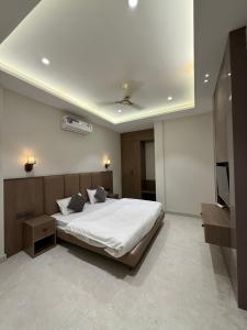 a bedroom with a bed and a flat screen tv at Hotel sky inn in Jalandhar +2 photos