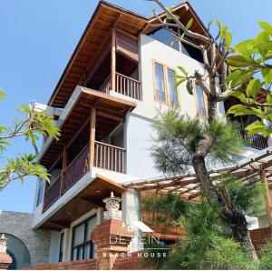 a house with balconies on the side of it at De'Rein Beach House in Sanur