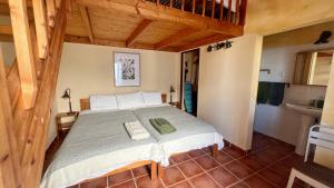 a bedroom with a large bed in a room at Casa Presente Guesthouse in Carrapateira
