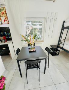 a dining room table with a vase of flowers on it at Villa Sila in Novalja +11 photos