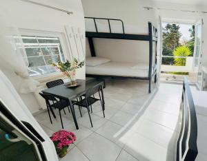 a small room with a table and a bunk bed at Villa Sila in Novalja