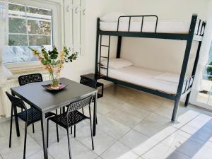 a dining room with a table and bunk beds at Villa Sila in Novalja