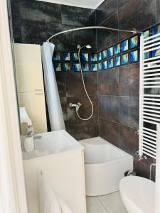 a bathroom with a tub and a sink and a toilet at Villa Sila in Novalja