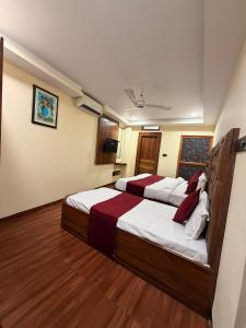 a bedroom with two beds in a room at Hotel SP international Lucknow in Lucknow +14 photos