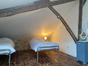 a room with two beds in a attic at Le Moulin du Clapier - La Ficelle in Sorges +5 photos