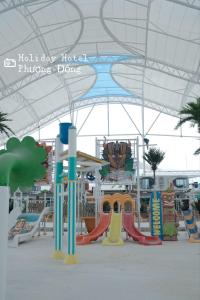 a playground with a slide and a play area at Holiday Hotel Van Don in Tài Xá