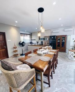 a kitchen and dining room with a wooden table and chairs at De'Rein Beach House in Sanur