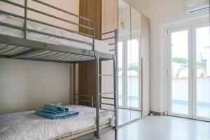 a bedroom with a bunk bed with towels on it at Villa Penelope in Terracina