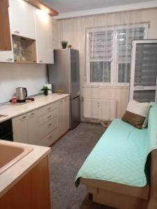 a small kitchen with a bench in the middle of it at ADELA Apartment center city in Ruse