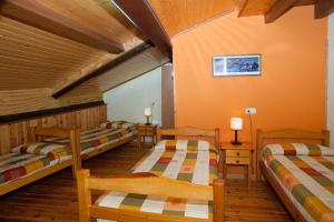 a room with three bunk beds in a cabin at Allotjament Rural Ca L'Anton in Pujal