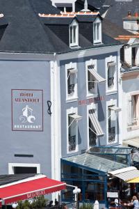 a large white building with a sign on it at Hotel Atlantique in Le Palais