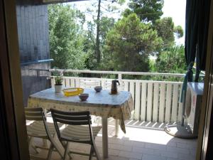 a table and two chairs on a porch with a view at Appartamento A Mare in Grado