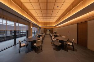 a dining room with tables and chairs in a building at Mungyeong Sadamjae Stay in Mungyeong