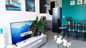 a living room with a large flat screen tv at Meerblick - widok na morze in Puck