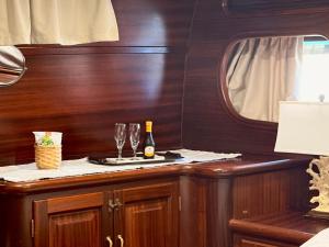 a table with two glasses and a bottle of wine at Caicco Silver Star 2 by Blue Marine in Lampedusa +7 photos