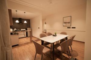 a dining room and kitchen with a table and chairs at Alpine Resort in Yelagiri +6 photos