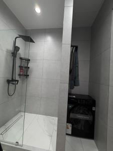 a shower with a glass door in a bathroom at NEST ONE - Floor 15 in Tashkent +8 photos