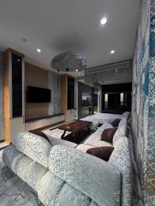 a living room with a large couch and a tv at NEST ONE - Floor 15 in Tashkent