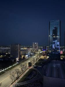 a view of a city at night with buildings at NEST ONE - Floor 15 in Tashkent