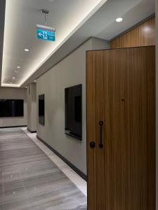 a hallway with a door and a sign on a wall at NEST ONE - Floor 15 in Tashkent