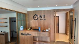 a lobby with a hotel sign on the wall at 611 Hotel in Phetchaburi