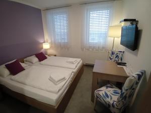 a bedroom with a bed and a table and a chair at AIS Center in Wolfsberg +37 photos