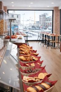 a buffet line with sandwiches and other food on display at Hotel Les Neus in Pas de la Casa