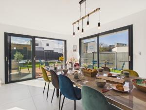 a dining room with a table and chairs at Superbe maison récente pour 8 avec jardin in Pléneuf-Val-André