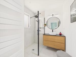 a bathroom with a sink and a mirror at Superbe maison récente pour 8 avec jardin in Pléneuf-Val-André +19 photos