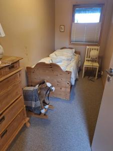 a small bedroom with a bed with a dresser and a desk at Slettavegen1a in Time