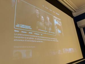 a projection screen on a wall in a room at Appartement Haussmann Spa et Ciné Experience in Nîmes