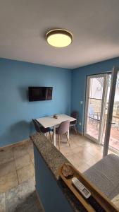 a living room with a table and a dining room at Apartment Bunjo's Beach House in Trogir