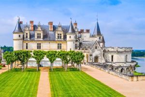 a castle with trees in front of it at Camping Loches in Loches