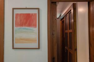 a picture hanging on a wall next to a door at MaPin in Ban Thung Kong Mu +9 photos