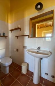 a bathroom with a sink and a toilet at Casa Presente Guesthouse in Carrapateira +19 photos