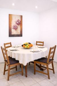 a dining room table with a bowl of fruit on it at Yviome Rhodes Central Escape in Rhodes Town +9 photos