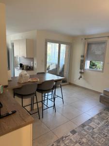a kitchen with a table and chairs in a room at Résidence inside in Ferney-Voltaire