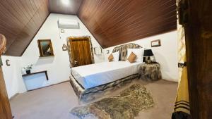 a bedroom with a large bed with a wooden ceiling at Nature Nest Cabana in Sigiriya