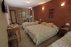 Cama ou camas em um quarto em Hotel Xumec Mendoza