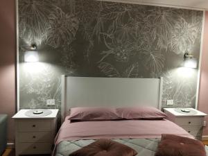 a bedroom with a bed with two night stands and two lamps at Residenza del Sepale in Viterbo +84 photos
