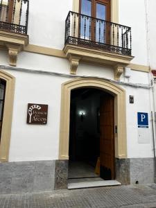 a building with a door and a balcony at Pensión Los Arcos in Córdoba