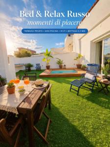 a flyer of a patio with a table and chairs at Bed & Relax in Lizzano